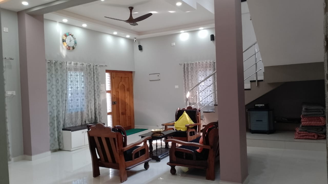 Bright living area with ceiling fan and garden-facing door